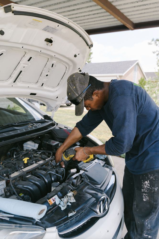 Erie mobile mechanic at work under a customer carport